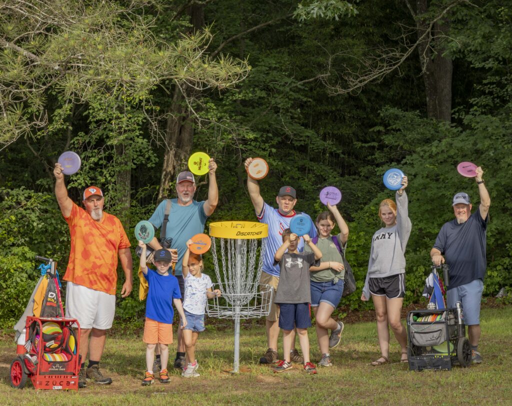 group playing disc golf