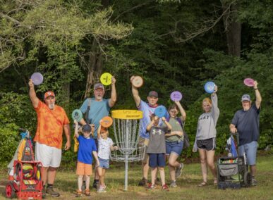 group playing disc golf
