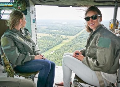 two girls riding in a helicopter
