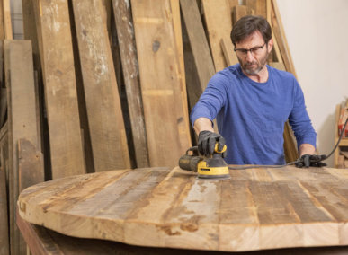 man sanding table