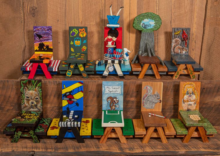 two rows of small painted picnic tables