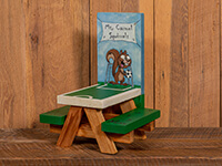 Small picnic table with cartoon squirrel holding a soccer ball with the table top looking like a soccer field