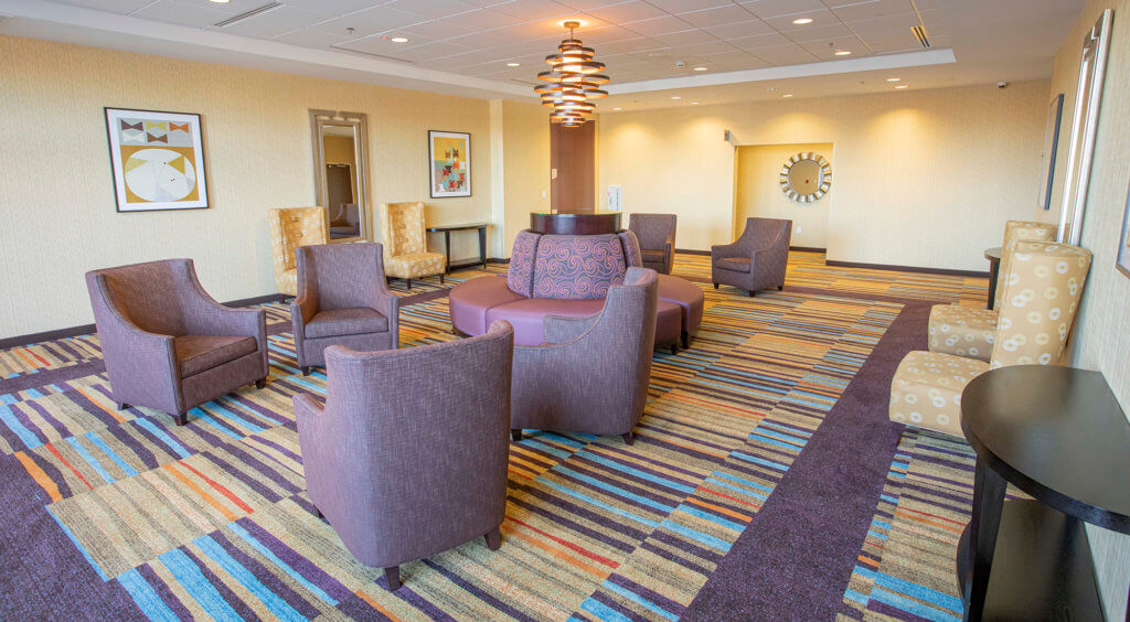 pre-function area outside Fairfield Inn ball room with stuffed chairs and small tables