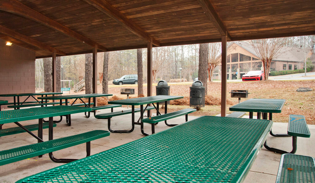 pavillion with picnic tables, grills and conference center in background
