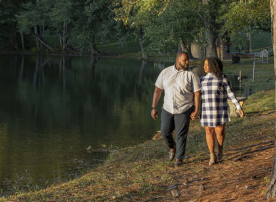 couple walks by lake