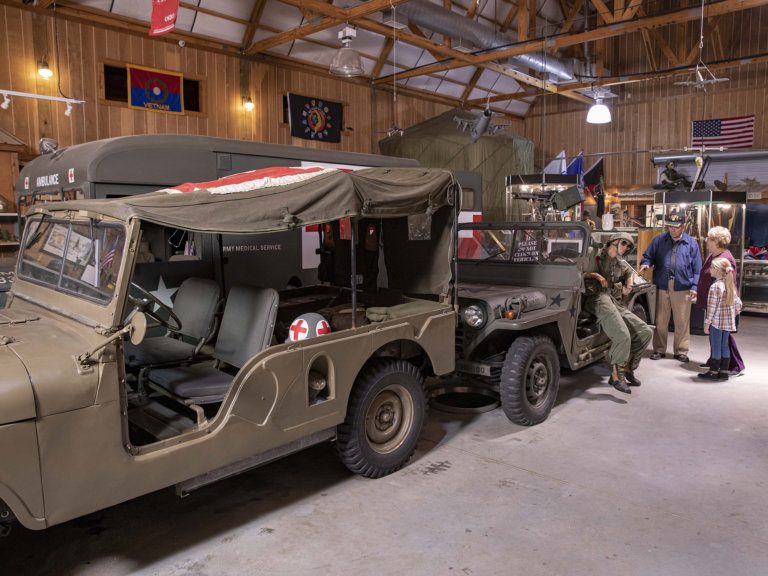 Veteran shows little girl historic vehicles
