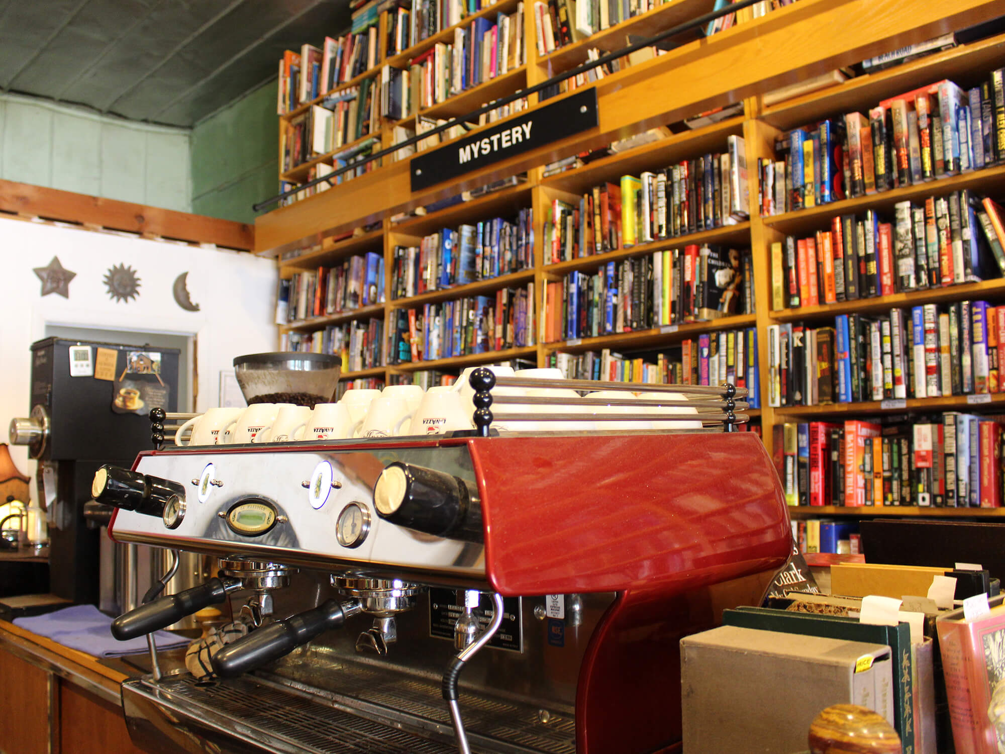 espresso machine with shelves of books in the background