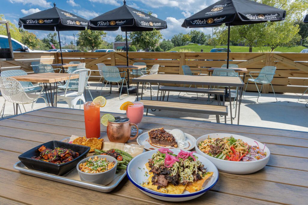 food and drinks on an outdoor patio table at a restaurant
