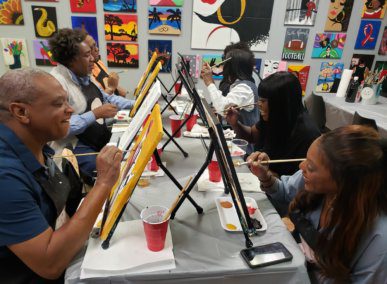 Picture of people with smiles and painting