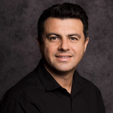 Headshot of a man against a black background