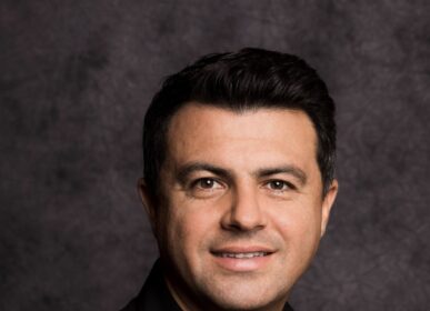 Headshot of a man against a black background