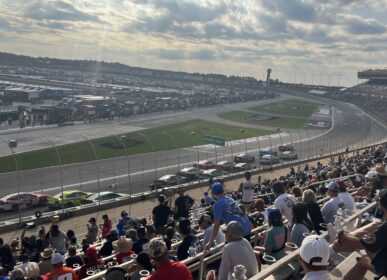 race cars on track with fans in stands