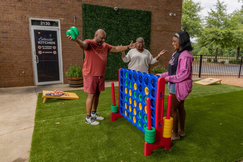 family playing connect 4 at culturistic kitchen