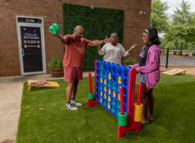 family playing connect 4 at culturistic kitchen