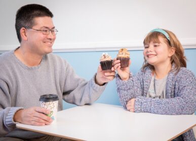 dad and daughter eating cupcakes from crumbles by nicole